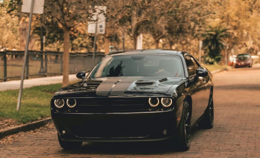 black coupe on concrete road