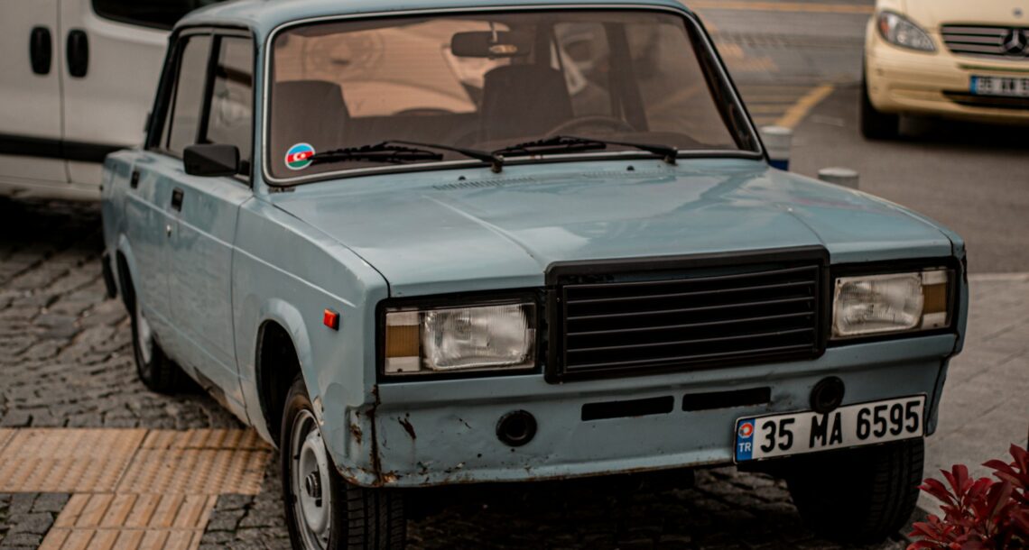 a blue car parked on the side of the road