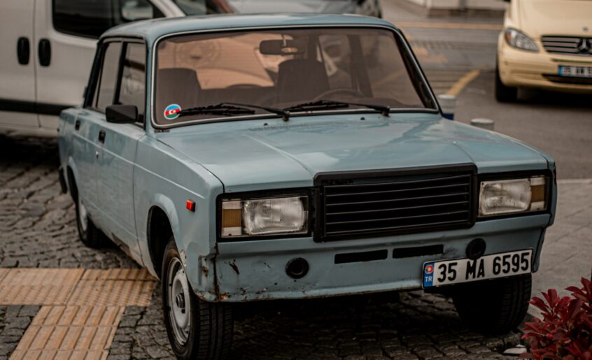 a blue car parked on the side of the road